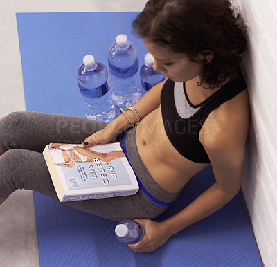 Buy stock photo Top view, diet and woman with a book, water and fitness for wellness, training and weight loss. Female person, human or model with liquid, reading or workout goal with a healthy lifestyle and fatigue