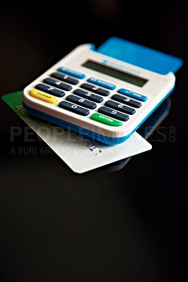 Buy stock photo A credit card underneath a calculator