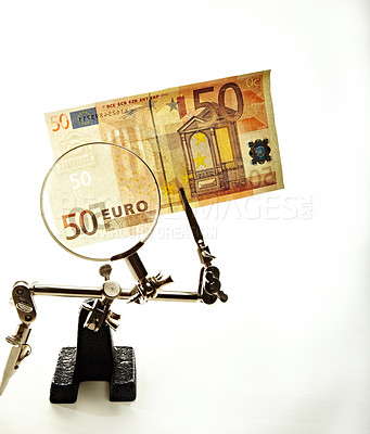 Buy stock photo A 50 Euro bill held up by a contraption with a magnifying glass 
