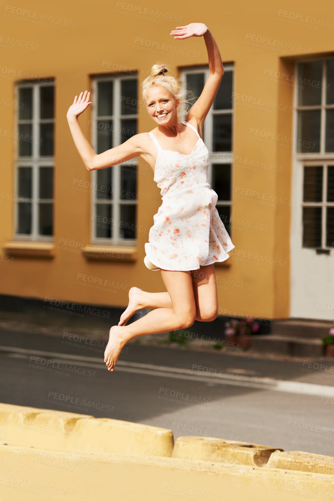 Buy stock photo Portrait, smile and jump with a woman during summer in her neighborhood for freedom or energy for life. Fashion, excited and a happy young person feeling carefree in an old town or city for adventure