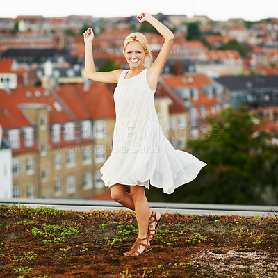 Buy stock photo Portrait, dance and smile with a woman on a roof in her neighborhood for energy or freedom in summer. Music, movement and a happy young person in celebration of her holiday or vacation as a tourist