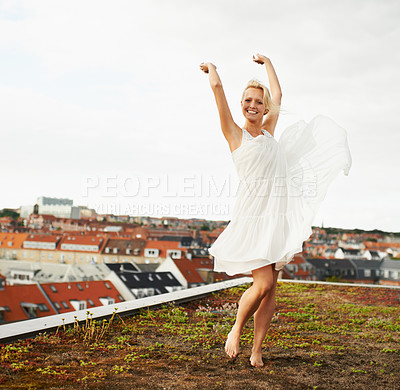 Buy stock photo Woman, happiness and dancing on rooftop, carefree and outdoor with freedom, smiling and city. Wind, dancer and urban area for break, summer and smile on trip, barefoot and amsterdam spring time
