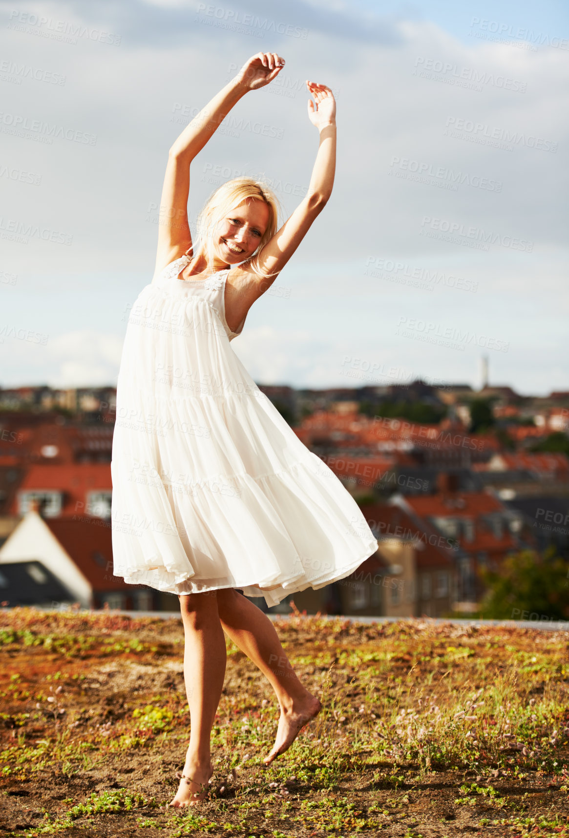 Buy stock photo Woman, joyful and dancer on vacation, summer and outdoor for holiday, smiling and dress. Rooftop, dancing and urban area for break, getaway and carefree on skyline, barefoot and amsterdam spring time