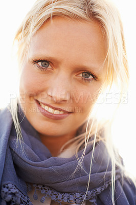 Buy stock photo A beautiful young woman smiling against bright sunlight