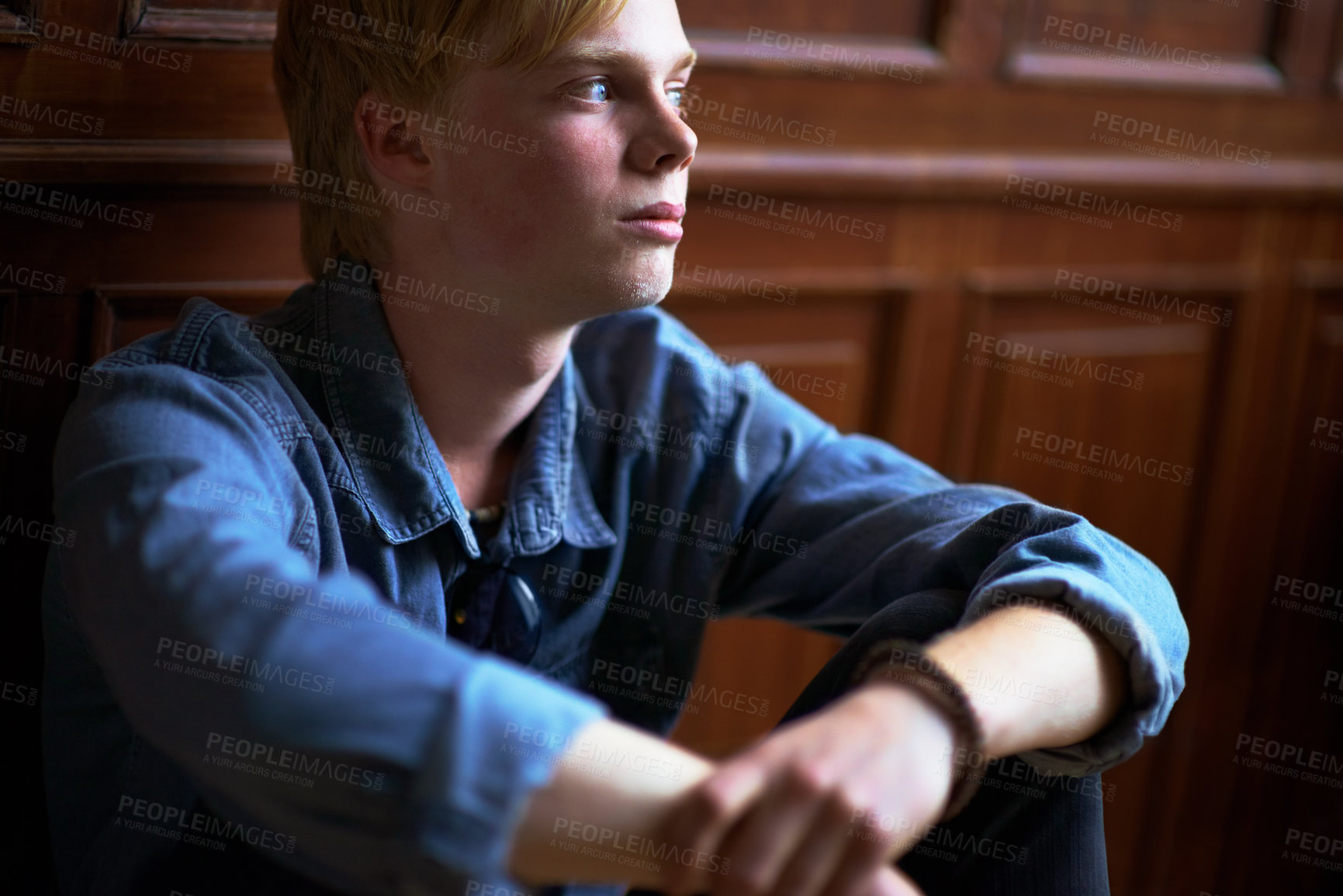 Buy stock photo Thinking, depression and an unhappy boy student at school as an outcast feeling lonely in a classroom. Education, scholarship and a sad young child in a class looking bored while alone on campus