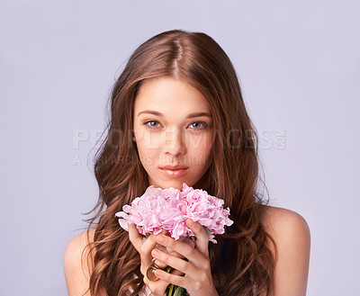 Buy stock photo Woman, portrait and bouquet for beauty in studio, wellness and skincare for care, makeup and cosmetic. Female model person, flowers and face for luxury, organic and aesthetic by purple background