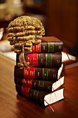 Buy stock photo Shot of legal books and a wig on top of a table