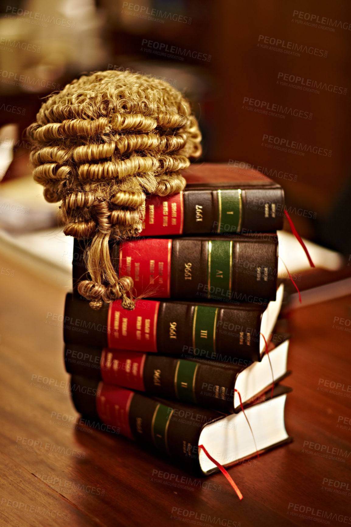 Buy stock photo Shot of legal books and a wig on top of a table