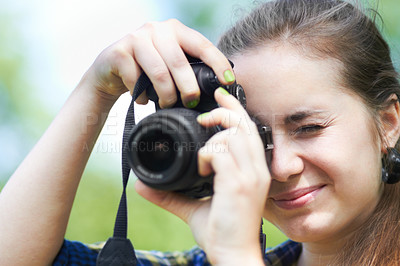 Buy stock photo A beautiful young woman taking a picture with her camera