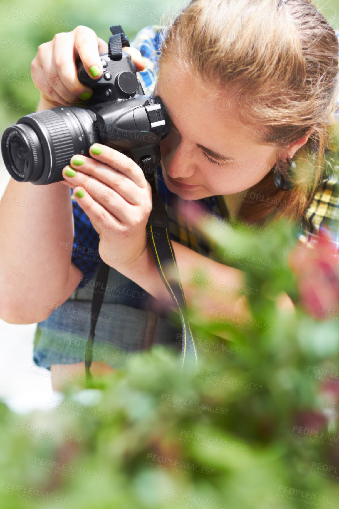 Buy stock photo A gorgeous young woman focusing through the lens of her camera