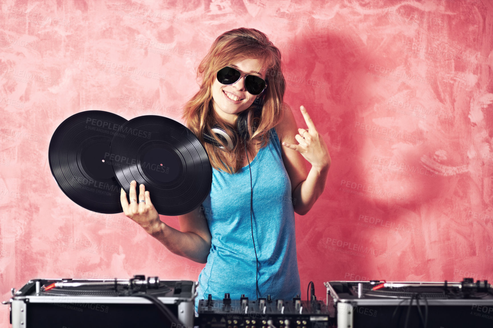 Buy stock photo DJ woman, mixer and smile in portrait with vinyl records, sunglasses and horns sign at club, studio or party. Girl, music and party with rock icon, turntable or attitude for event, celebration or job