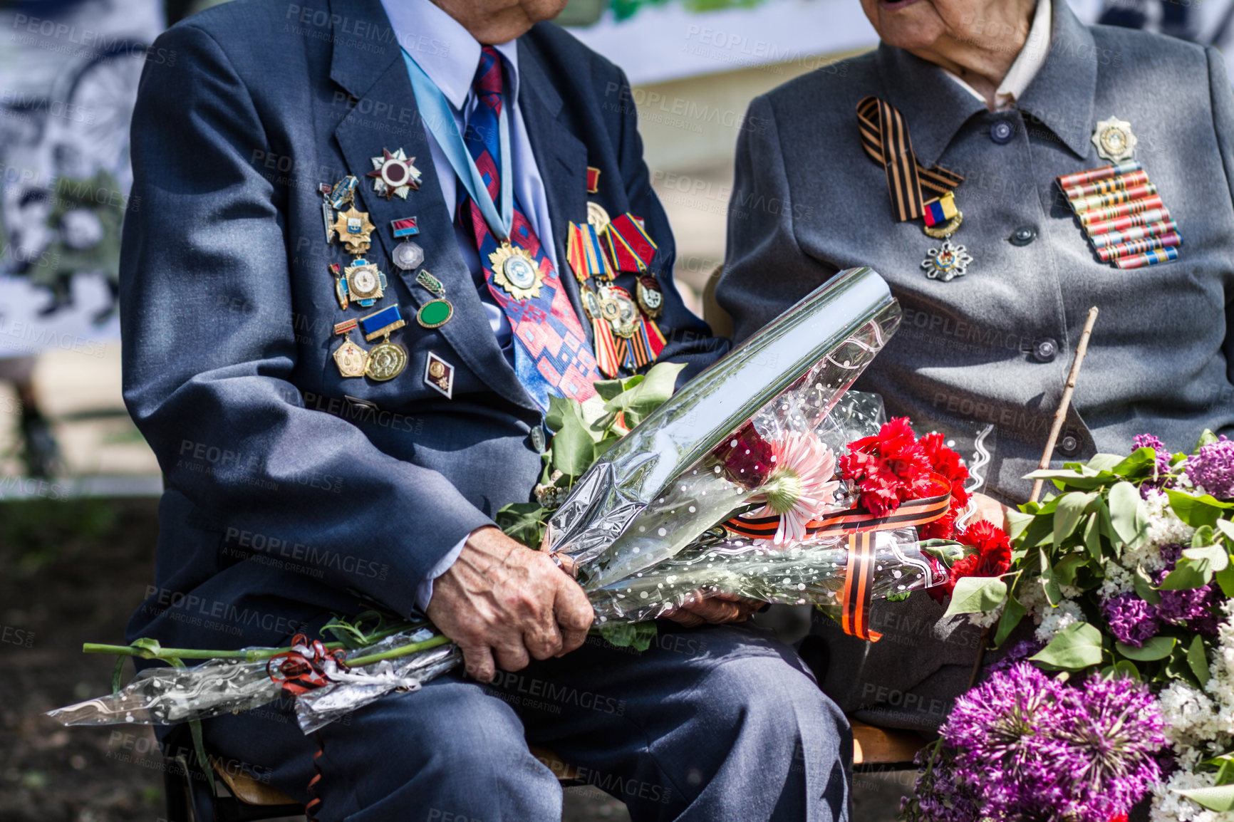 Buy stock photo Cropped image of two war veterans holding flowers at a funeral