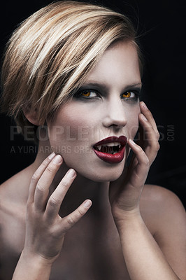 Buy stock photo Portrait, hands and a woman vampire in studio on a dark background for halloween or cosplay. Fantasy, horror or fangs with an attractive young female monster posing as an evil and surreal creature