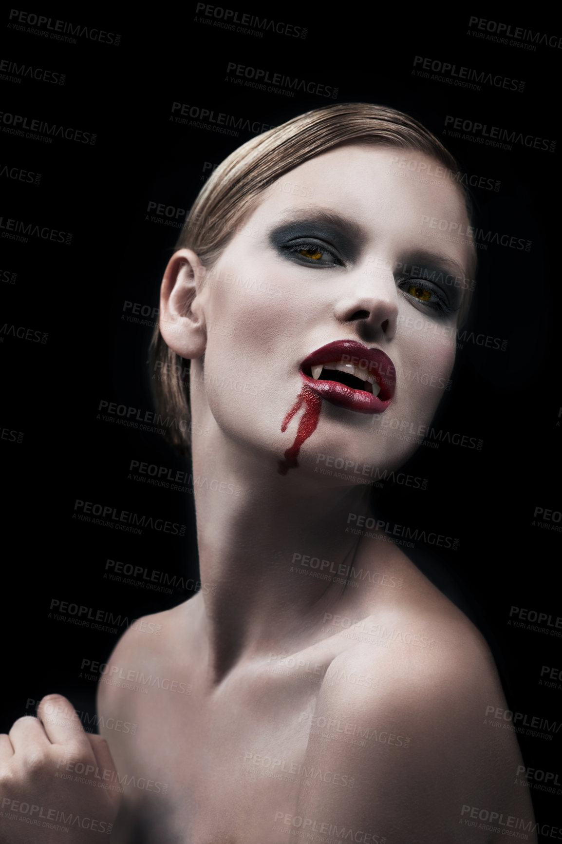 Buy stock photo Portrait, woman and vampire with blood, lady and bare against a dark studio background. Face, female character and girl with fantasy, makeup and cosmetics with cosplay, person and supernatural being