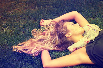 Buy stock photo An attractive  young girl sleeping on the grass outside