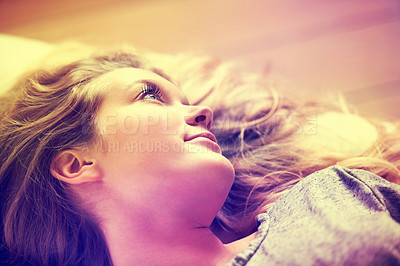 Buy stock photo An attractive young girl lying on her couch at home