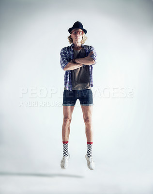 Buy stock photo Portrait, jumping and man with fashion, retro and streetwear with confident guy isolated on a white studio background. Person, model and hipster with casual outfit, trendy clothes and floating in air
