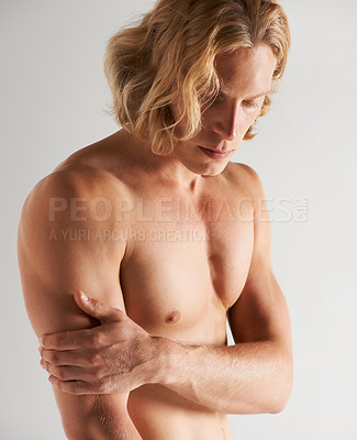 Buy stock photo Studio shot of a handsome young shirtless man