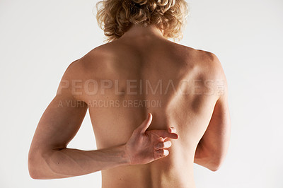 Buy stock photo Rear view of a young shirtless man gesturing behind his back