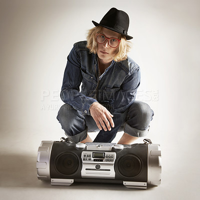 Buy stock photo Boombox, fashion and portrait of a man in retro style in studio with music, radio or sound. Male model person on a grey background with denim outfit, glasses and hipster hat listening to audio