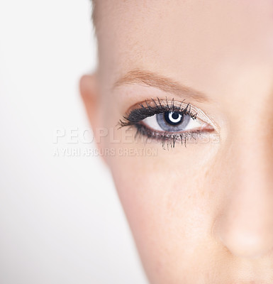 Buy stock photo Beauty, eye and half portrait of woman with natural makeup, facial spa treatment and aesthetic dermatology in studio. Vision, skin care and face of model with light, wellness and white background.