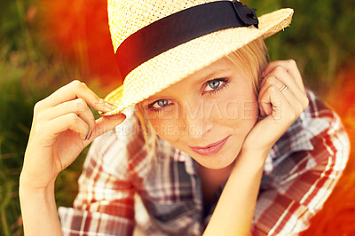Buy stock photo Lomography style portrait of a young woman sitting in a field