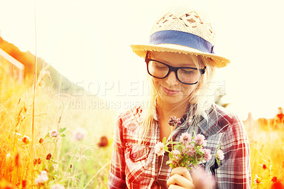 Buy stock photo Lens flare, countryside and woman with flowers in field for freedom, wellness and fresh air outdoors. Nature, summer and happy female person in natural meadow for relaxing, calm and peace in morning