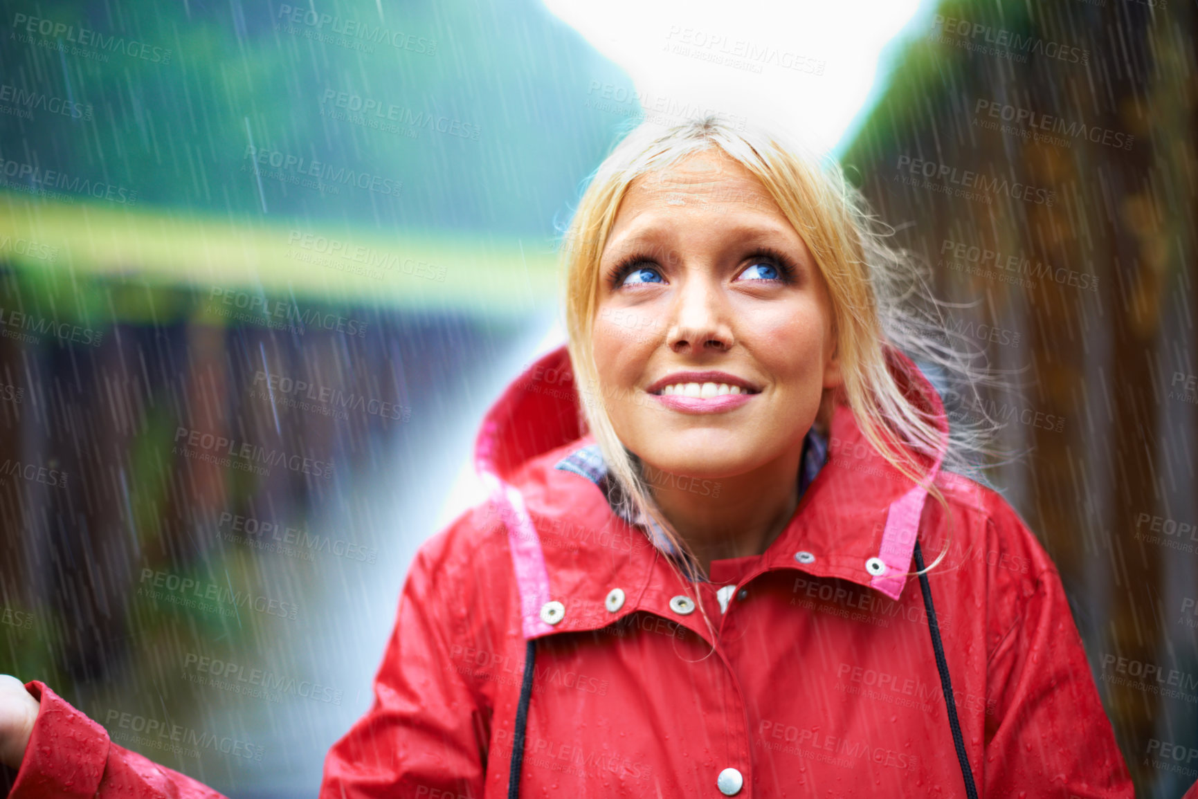 Buy stock photo Woman, smile and raincoat for rain in nature, wet and cold from weather, winter and outdoor. Happy female person, fashion and red jacket is cool, rainfall and protection from water, face and vacation