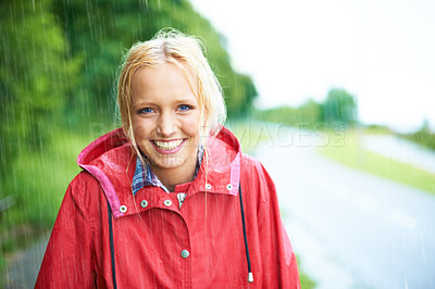 Buy stock photo Woman, smile and raincoat in outdoor weather, wet and cold from rain, winter and nature. Happy female person, fashion and red jacket is stylish, rainfall and protection from water, face and portrait