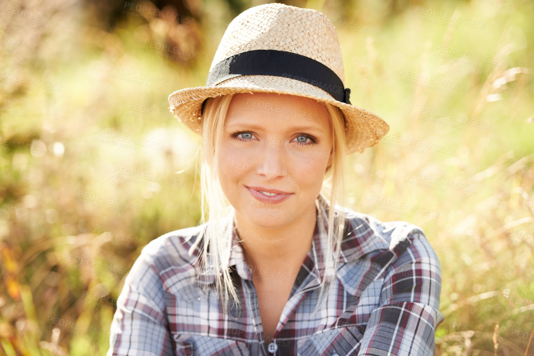 Buy stock photo Happy, portrait and young woman in nature with a straw hat sitting in an outdoor garden for fresh air. Smile, fashion and female person from Australia in the forest, woods or field with casual style.