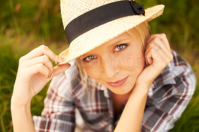 Buy stock photo Smile, portrait and young woman in nature with a straw hat sitting in an outdoor garden for fresh air. Happy, fashion and female person from Australia in the forest, woods or field with casual style.