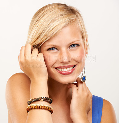 Buy stock photo Portrait of an attractive young woman touching her hair
