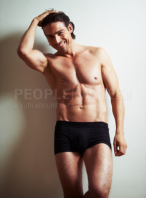 Buy stock photo Portrait of a sexy semi-nude young man leaning against a wall