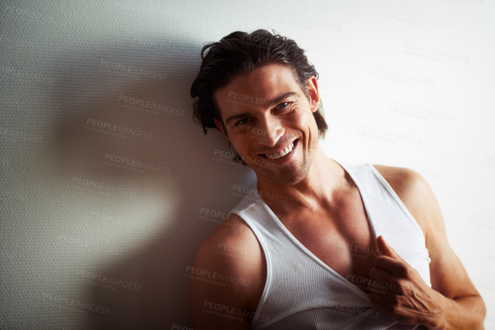 Buy stock photo Smile, portrait of man in a studio with tank top for strong, fitness and muscles with confidence. Happy, attractive and handsome male model posing in stylish vest isolated by white background.