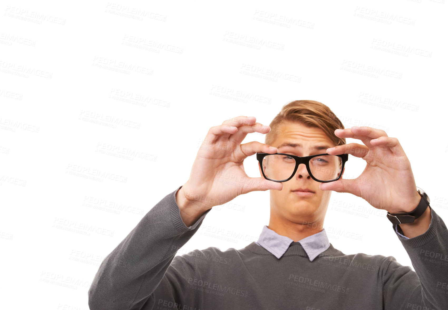 Buy stock photo Studio shot of a young man squinting through a pair of glasses while isolated on white