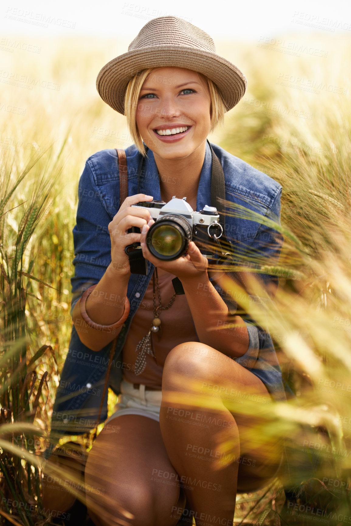 Buy stock photo Portrait of an attractive young woman holding a camera