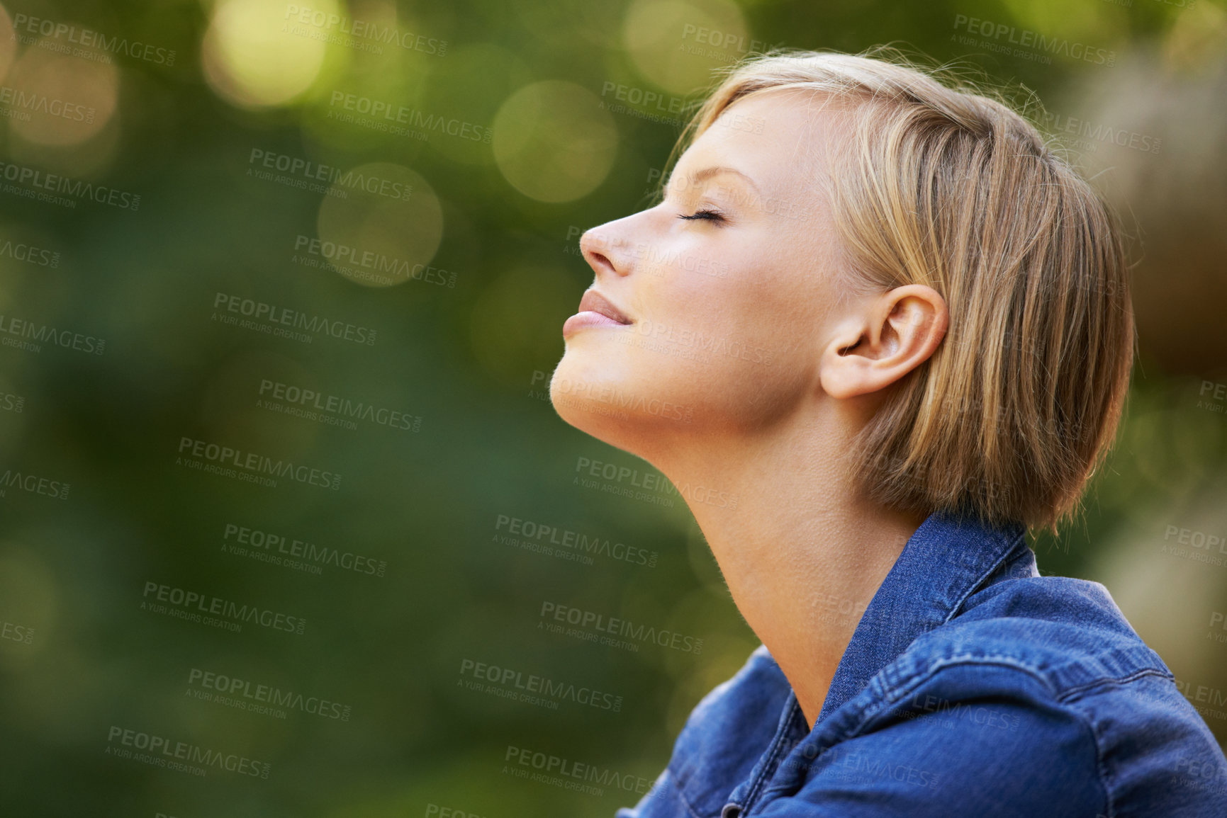 Buy stock photo A young woman outdoors with her eyes closed beside copyspace