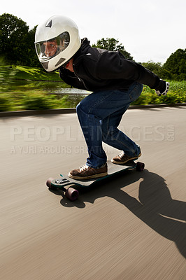 Buy stock photo Man, skateboard and speed with motion blur in street with helmet for exercise, fitness and outdoor in summer. Person, skating and fast in road with thinking for extreme sports, training or moving