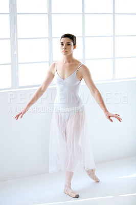 Buy stock photo Dance, ballet and focus with woman in studio for balance, elegant and performance. Artist, theatre and training with female ballerina dancing in class for competition, freedom and commitment