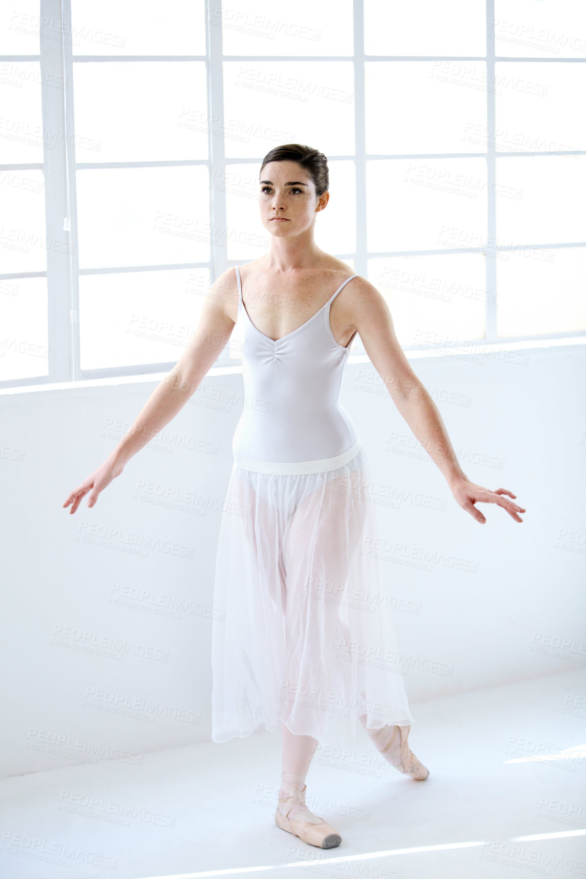 Buy stock photo Dance, ballet and focus with woman in studio for balance, elegant and performance. Artist, theatre and training with female ballerina dancing in class for competition, freedom and commitment