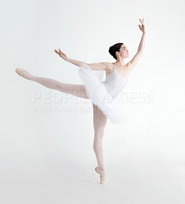 Buy stock photo Elegant young ballerina dancing en pointe against a white background