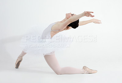 Buy stock photo Creative, dance and ballet with a woman in studio on a white background for rehearsal or recital for theatre performance. Art, flexible and music with a young female ballerina or dancer in uniform
