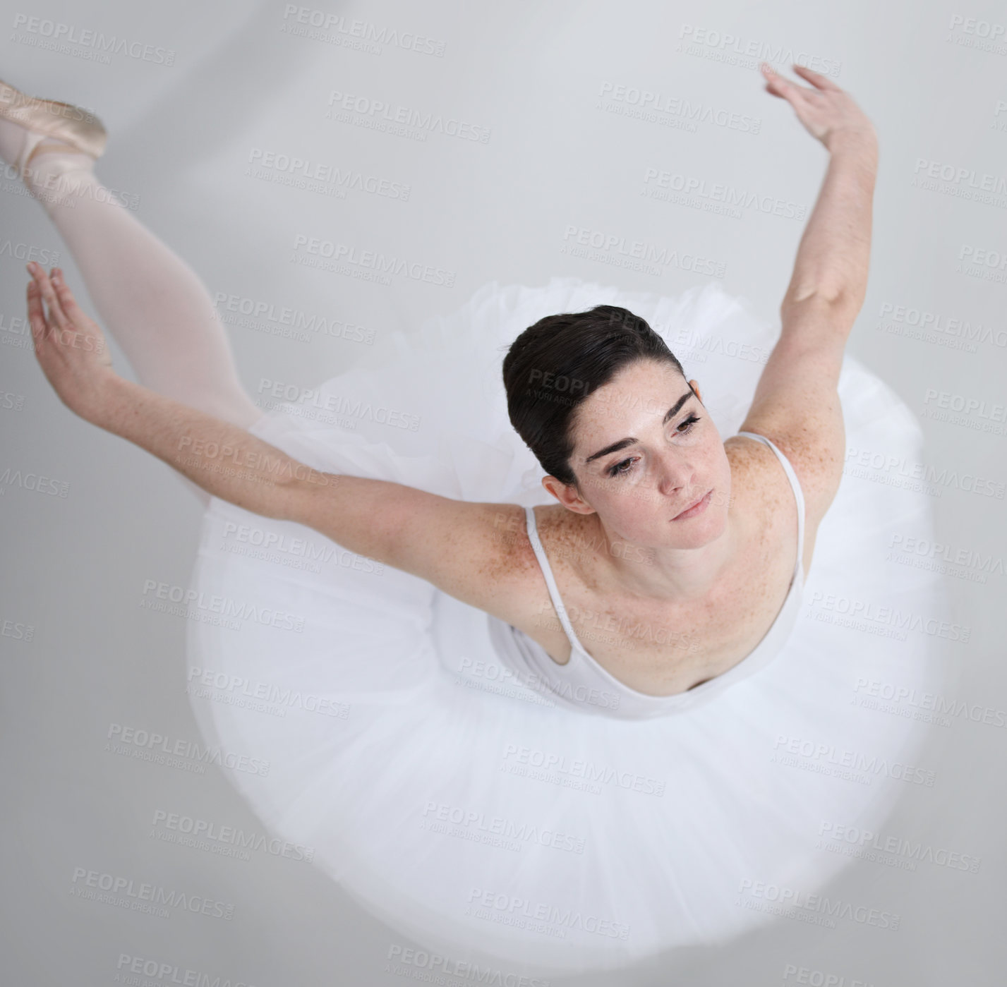 Buy stock photo Supple young ballerina dancing against a white background