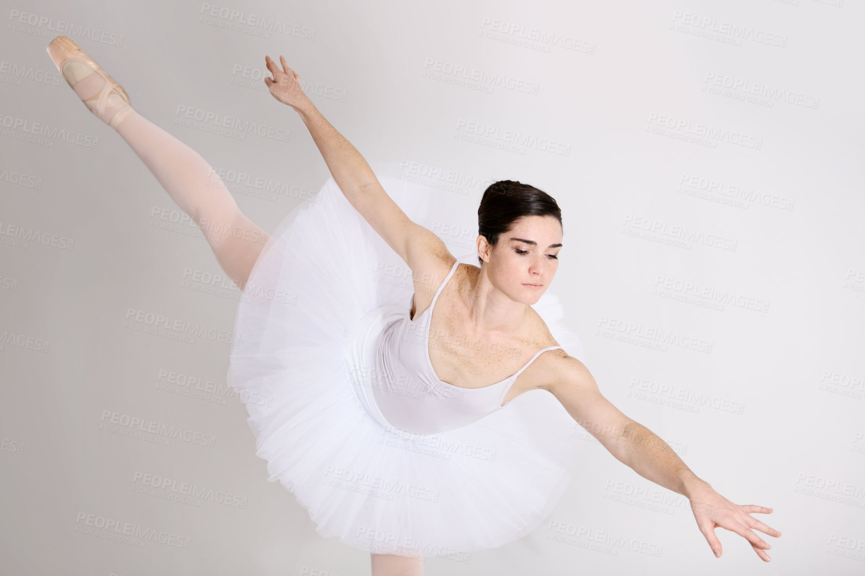 Buy stock photo Balance, dance and ballet with a woman in studio on a white background for rehearsal or recital for theatre performance. Art, creative and elegance with a young female ballerina or dancer in uniform