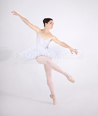 Buy stock photo Elegance, dance and ballet with a woman in studio on a white background for rehearsal or recital for theatre performance. Art, creative and balance with a classy young ballerina or dancer in uniform