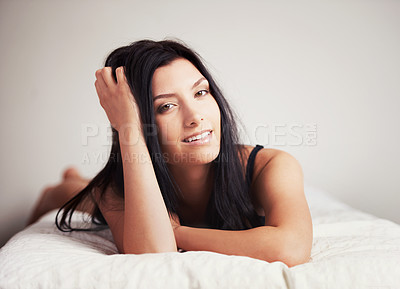 Buy stock photo Portrait of a sexy young brunette lying on her bed seductivley