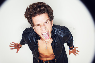 Buy stock photo Man, tongue and leather jacket in studio portrait with spotlight, fashion and clothes by white background. Person, top view and rockstar for crazy face, shouting or jewelry for punk aesthetic