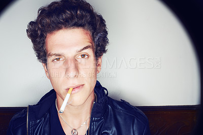 Buy stock photo Portrait of man with cigarette, punk fashion and rockstar attitude on white background with spotlight. Cool rock style, modern creative and smoking, confident face of handsome male model in studio.