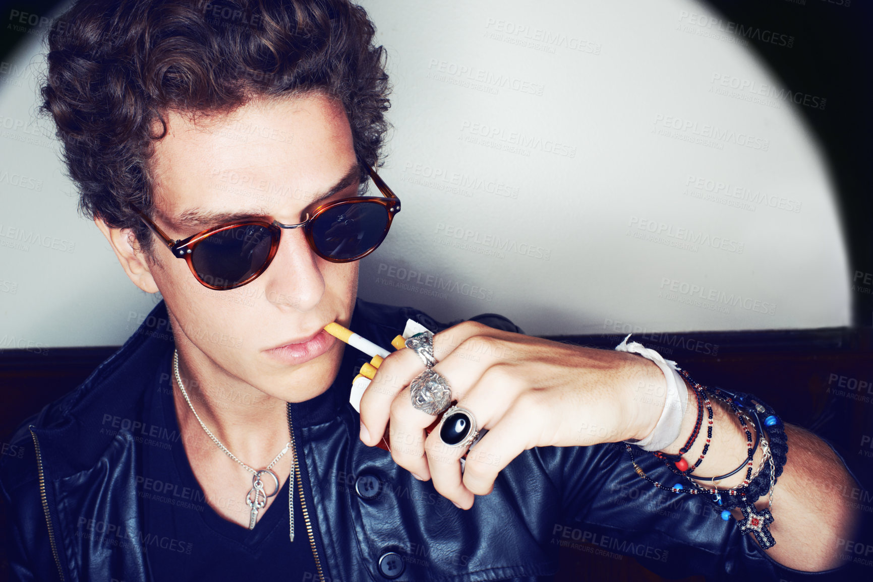 Buy stock photo Portrait of man with cigarette, rock fashion and rockstar attitude on white background in spotlight. Cool punk style,  grunge and smoking, confident and handsome male model in studio with sunglasses