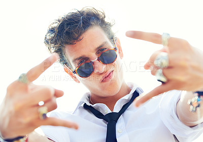 Buy stock photo Portrait, punk and man with sunglasses, grunge and fashion with style, rock and trendy. Modern outfit, person and guy with rings, jewelry and eyewear with sunshine, fun and excited with hand gesture